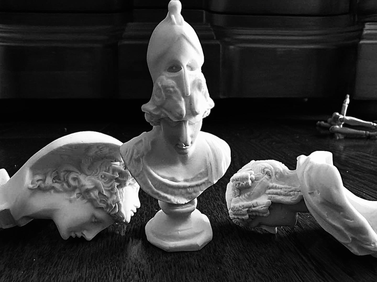 Black and white photo of classical sculpture busts.