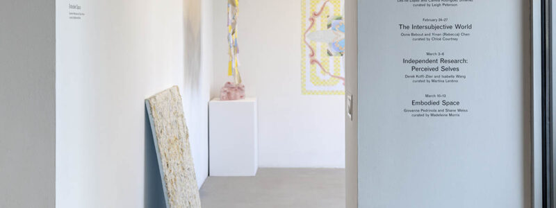 View of entrance to exhibition, with title wall at left.