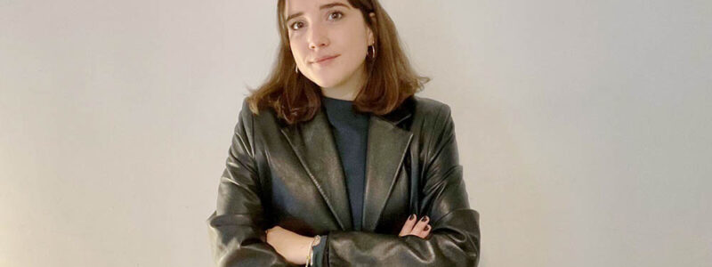 Photo of Sofia Ohmer in front of a blank white wall.