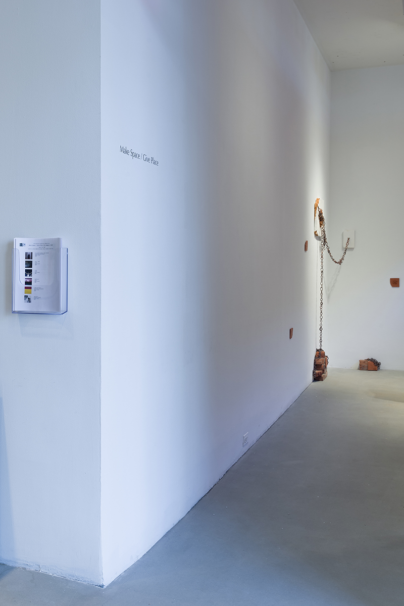 Installation view, title wall with text "Make Space / Give Place"