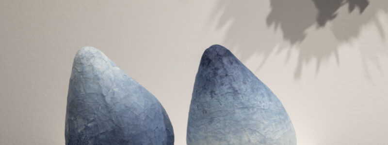 Blue and white conical objects made from paper.